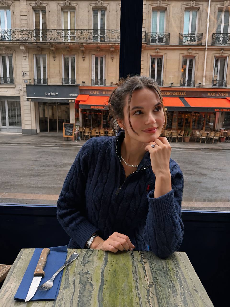 Maria at a café in Paris
